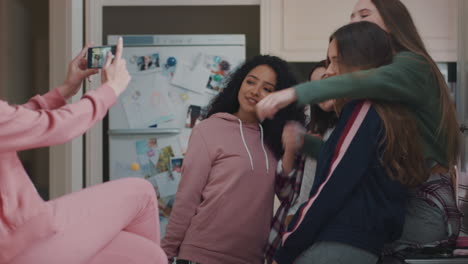 group-of-teenage-girls-taking-photos-using-smartphone-posing-enjoying-hanging-out-together-sharing-party-weekend-on-social-media