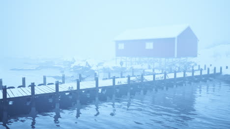 red cabin on a foggy winter day