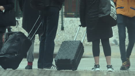 personas con maletas en un cruce de peatones