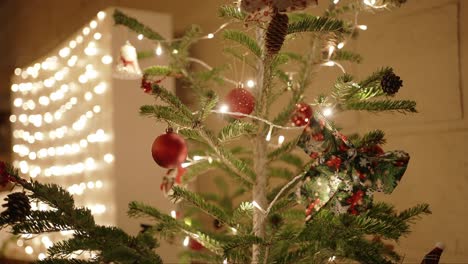 decorated christmas tree with warm fairy lights and festive ornaments indoors