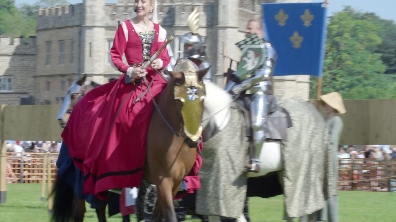 Marshal of the Field greets the mounted knights at the arena of the Queen's tournament Joust at Leeds Castle, Kent, England