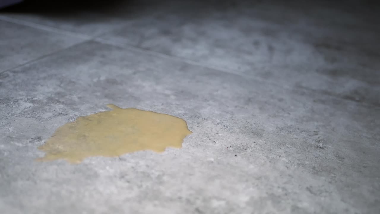 Spotted Liquid on Grey Tile Floor