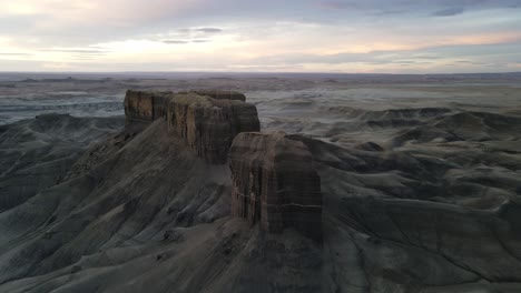 revealing aerial shot of rugged rocky terrain near factory butte,utah