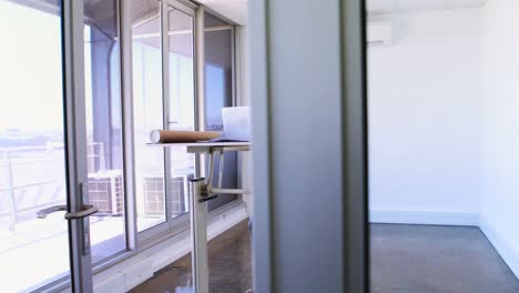 female architect talking on mobile phone while working on blueprint over drafting table 4k