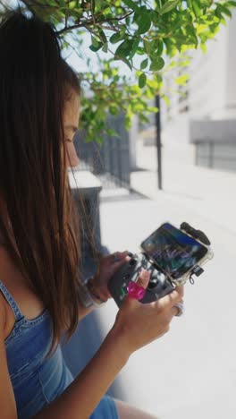 a person playing a mobile game with a controller and smartphone outdoors