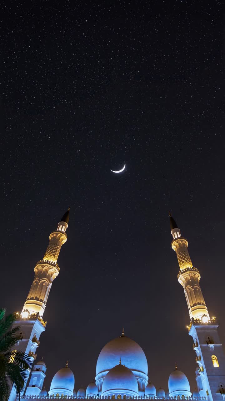 Low-angle shot of a mosque at night with a crescent moon and starry sky ...