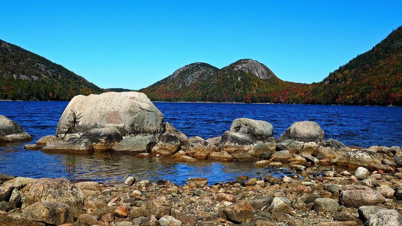 Sunny autumn day near Jordan Pond in Acadia with Bubbles Mountain