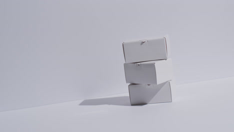 video of stacked cardboard boxes with copy space over white background