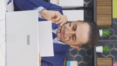 Vertical-video-of-Businessman-thinks-looking-at-documents.