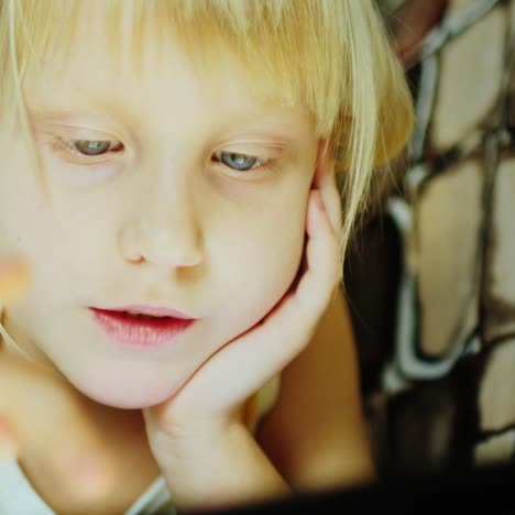 little girl using a computer tablet close up 01