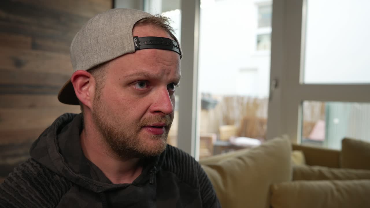 GAMING - Millennial man focusing while playing a video game, close up