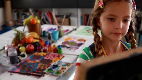 Cute-schoolgirl-painting-on-canvas-4k