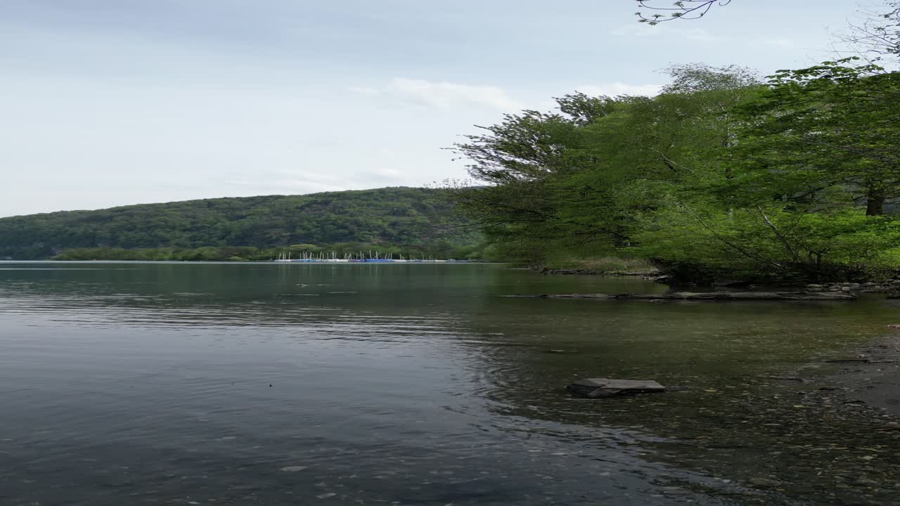 Flying low above the surface Lake water basin in small village in G&auml;si Betlis, Walensee Glarus, Weesen Walenstadt, Switzerland- drone view