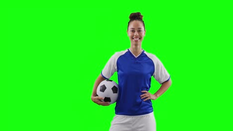 Video-of-caucasian-female-football-player-holding-football-and-copy-space-on-green-screen