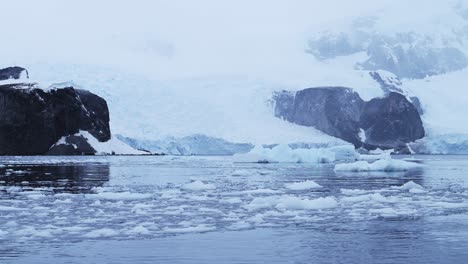 Sea-Ice-and-Big-Beautiful-Glacier-in-Winter-Landscape-in-Antarctica-on-Zodiac-Boat-Trip-Tour-Excursion-on-Antarctic-Peninsula,-Tracking-Moving-Shot-with-Movement-in-Icy-Winter-Scenery