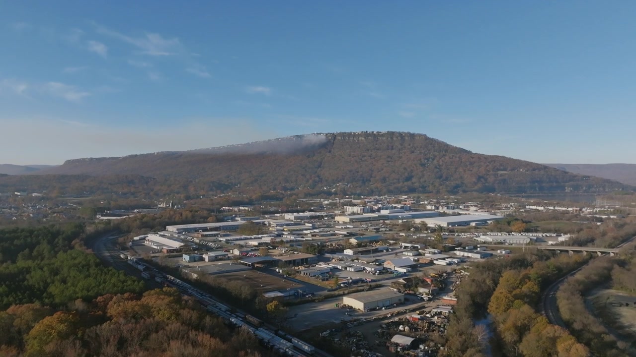 Aerial footage flying over Lookout Creek with Lookout Mountain in the background in the morning with a forest fire burning.