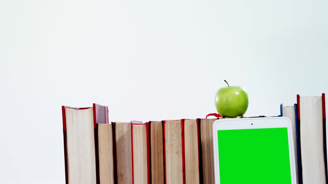 Apple, digital tablet and books on white background