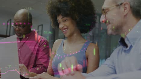 Animation-of-financial-data-processing-over-diverse-man-and-woman-discussing-over-a-laptop-at-office