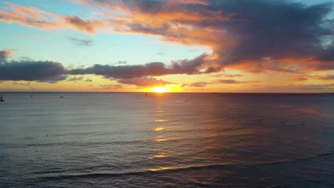 colorful ocean sunrise with beautiful reflection over waikiki beach in honolulu, hawaii