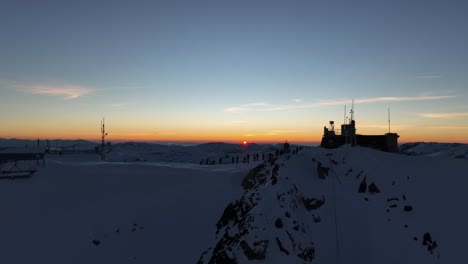 Drone-shot-passing-through-Musala-peak,-summit-during-sunset,-dusk,-Bulgaria,-Rila-mountain,-highest-summit-on-the-Balkans,-clear-sky,-amazing,-stunning-view,-twilight,-blue-hour,-golden-hour
