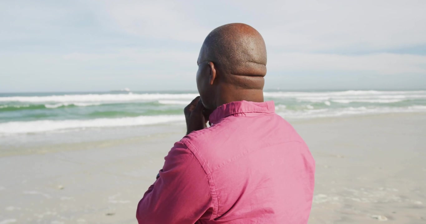 Man Standing on Beach Looking at Social Media Notifications