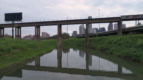 this video is about an aerial view of the buffalo bayou near downtown houston on a cloudy day