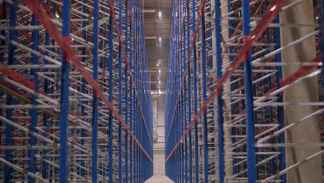 big and modern warehouse under construction, featuring metal shelving and other industrial equipment.