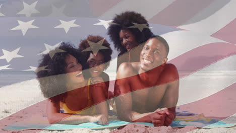 animación de la bandera de los estados unidos de américa sobre una feliz familia afroamericana en la playa
