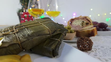 slider shot of venezuelan hallaca dish served with festive atmosphere in the background