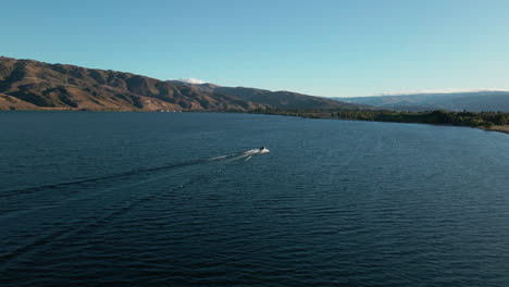 Motorboat-crossing-wide-blue-Clutha-river-in-New-Zealand