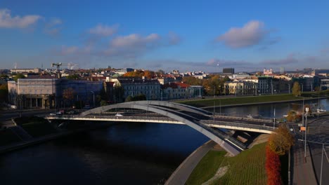 Skyline-of-Vilnius-rising-above-Neris-river-and-bridge-crane-aerial