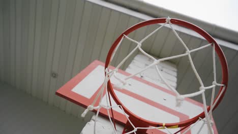 a basketball net hangs in the yard. shooting the grid in motion