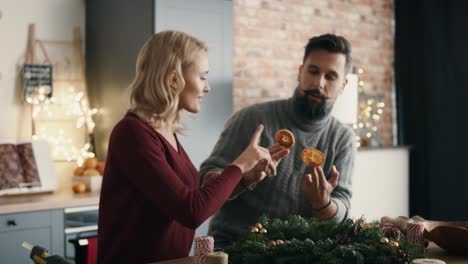 couple preparing christmas decorations together