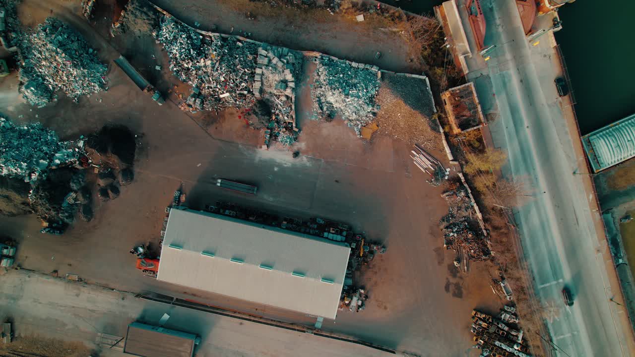 Top-down perspective of a busy steel recycling yard in South Chicago, displaying massive scrap piles and industrial infrastructure.