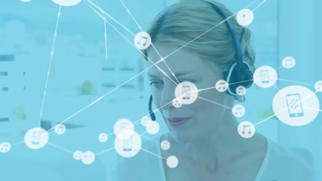 Animation-of-network-of-connections-with-icons-over-caucasian-woman-working-in-call-center