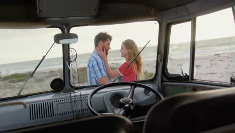 couple embracing each other near camper van 4k