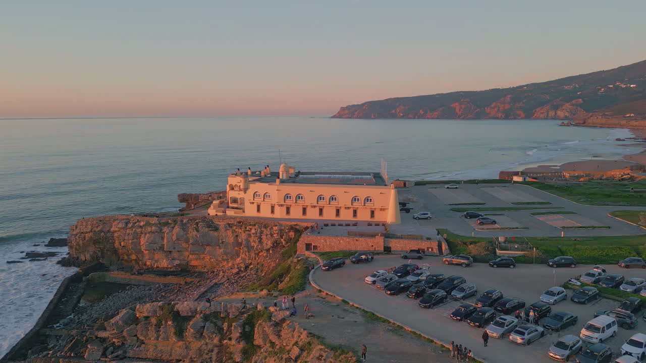 Touristic complex sunset panorama. Drone view ocean landscape of rocky shore