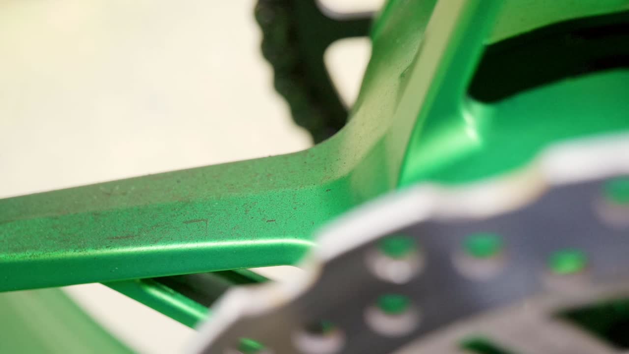 Close up of green motorbike wheel with dust and dirt on - extreme tight shot