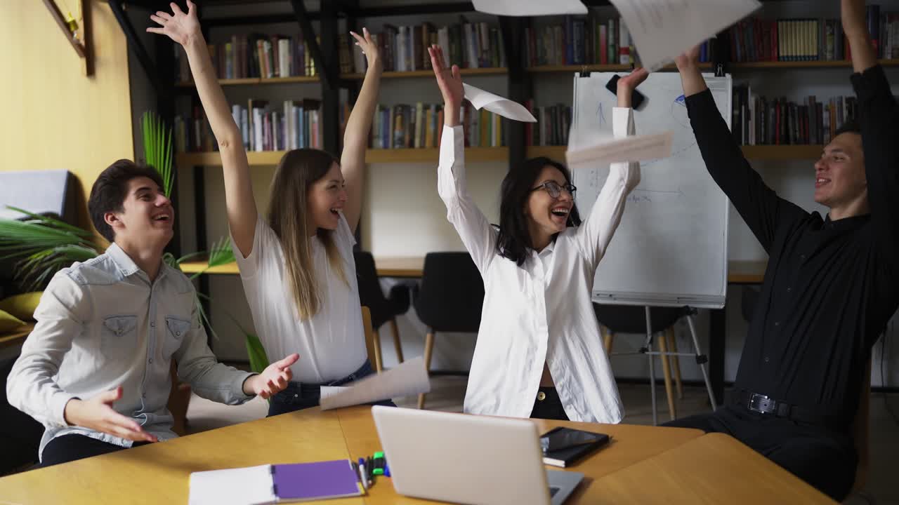 grupo motivado disfruta del éxito. arrojando el papel como un signo de éxito. jóvenes y su mentor