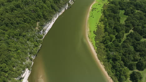 beaver lake's shoreline in arkansas, showing green water and lush forest, aerial view