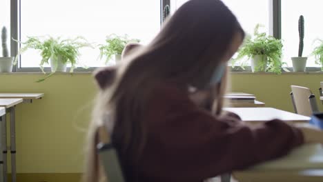 side view of students sitting in the classroom during a pandemic