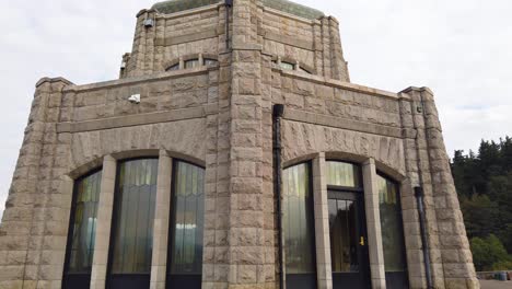 4K-Tight-with-slight-zoom-out-and-then-zoom-back-in-tight-circling-counter-clockwise-around-the-Vista-House-on-Historic-Columbia-River-Highway-with-mostly-cloudy-sky-take-five