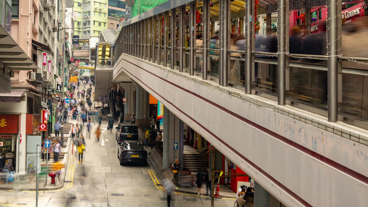 HONG KONG - 19 MARCH 2025 : Timelapse looking down onto a street scene in Hong Kong Central
