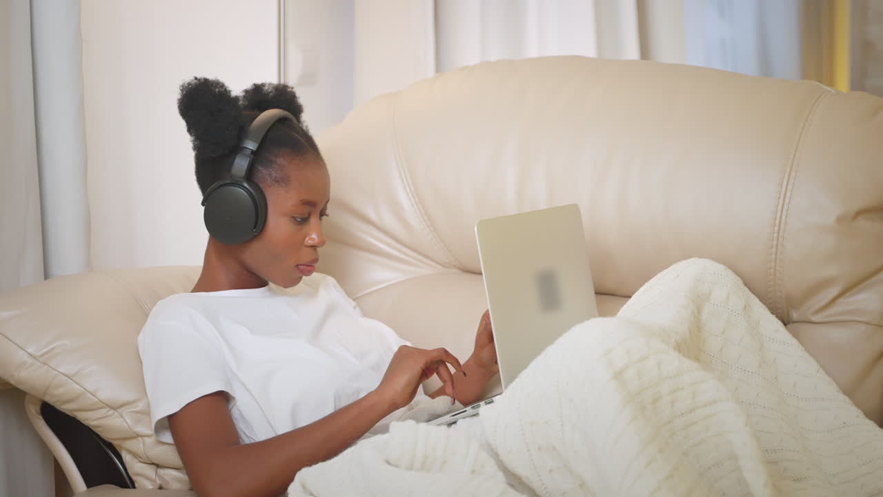 Woman Relaxing and Working on Laptop