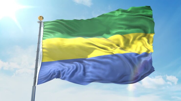 Bandiera del Gabon che sventola al vento contro un cielo blu intenso. Tema nazionale, concetto internazionale. Render 3D, Loop Continuo 4K.