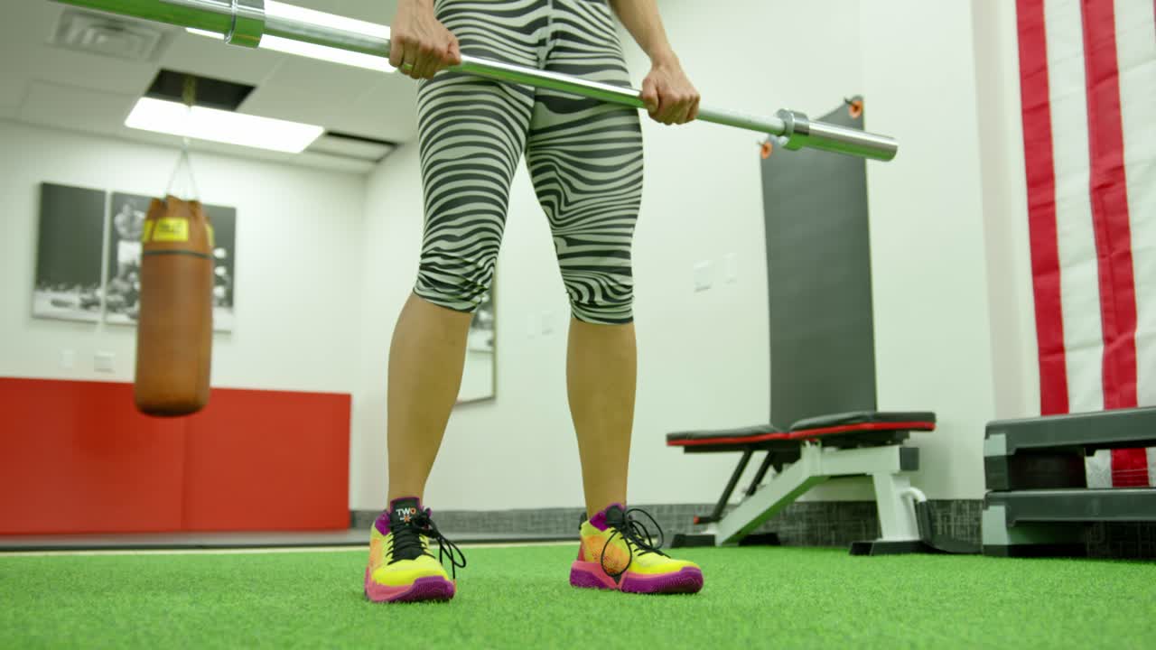 Active woman exercising in fitness hall