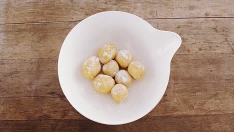 round dough balls kept in a bowl 4k