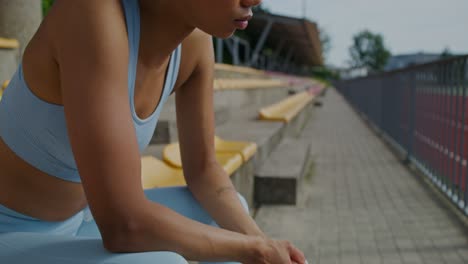 woman resting after workout at stadium