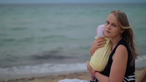 sad mum with baby near the sea