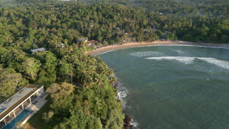 high establishing aerial drone shot over hiriketiya beach and bay in south sri lanka 60 fps